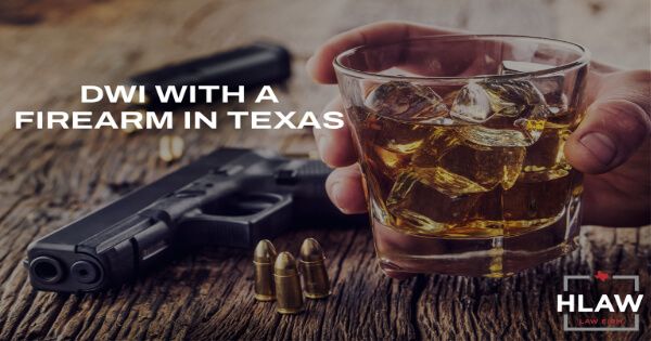 DWI with a firearm in Texas: handgun and bullets beside a glass of whiskey