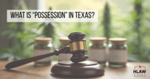 A judge’s gavel in front of cannabis containers, representing legal possession laws in Texas.