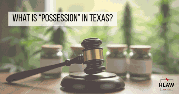 A judge’s gavel in front of cannabis containers, representing legal possession laws in Texas.