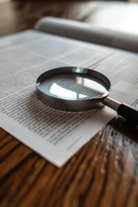 Image of a magnifying glass over documents or an accident scene, symbolizing proving negligence