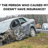 A severely damaged car on the side of a road, illustrating a blog post about what to do after a car wreck with an uninsured driver in Texas.
