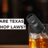 Glass of whiskey with car key inside on a bar counter, symbolizing the dangers of drunk driving and Texas dram shop liability for overserving alcohol.